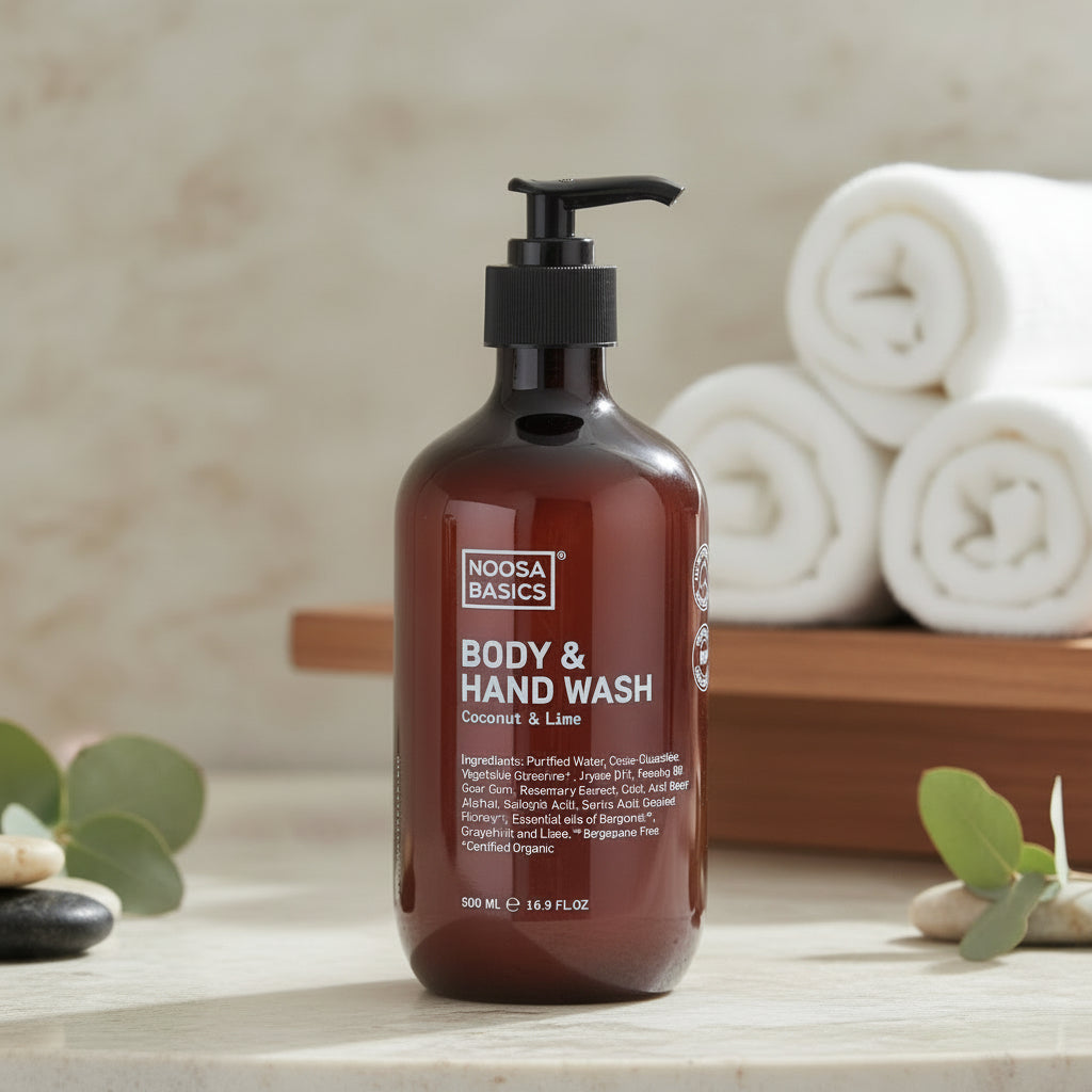 Noosa Naturals body and hand wash bottle on a wooden surface with a neutral background