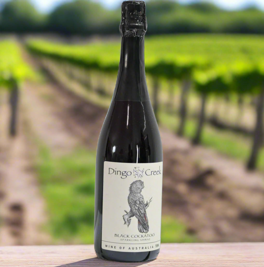 Wine bottle with 'Dingo Creek' label on a white background