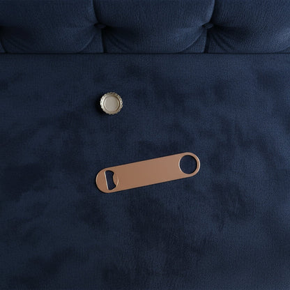 Navy blue fabric with a gold button and brown leather bottle opener on a dark background