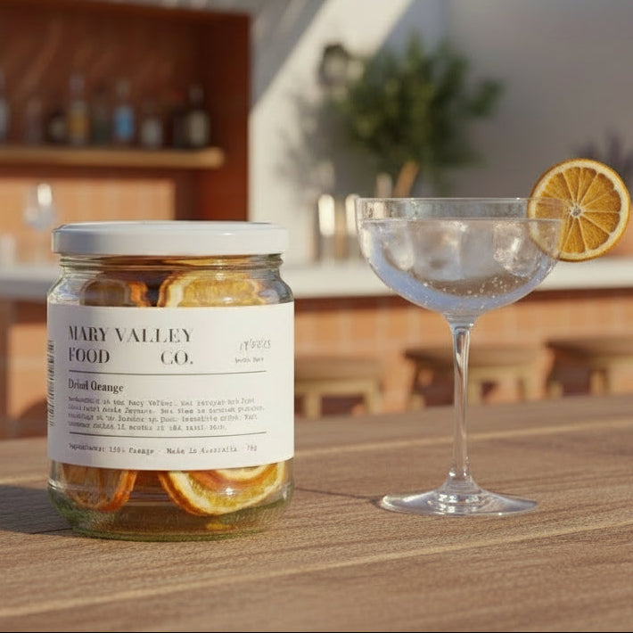 Jar of dried oranges from Mary Valley Food Co. on a plain background