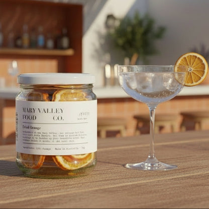 Jar of dried oranges from Mary Valley Food Co. on a plain background