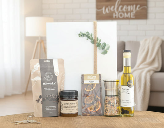 Collection of coffee beans, olive oil, and other products on a wooden surface with a neutral background